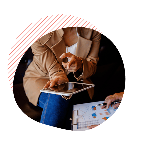 Ladies hand holding a tablet computer and looking at spreadsheets